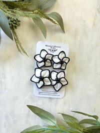 Image 1 of White and Black flowers 