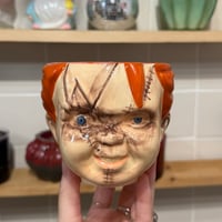 Image 1 of orange vanilla sugar cookie scented chucky candle