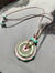 Image of springpop; effetre glass medallion with accent beads and leather cord