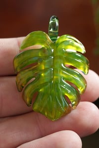 Image 1 of neon monstera leaf pendant. 