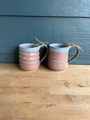 Image of M46 Matching blue lip over pink glazed mugs, medium wider.