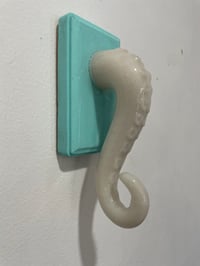 Image 2 of Single glow in the dark tentacle on teal jewelry holder