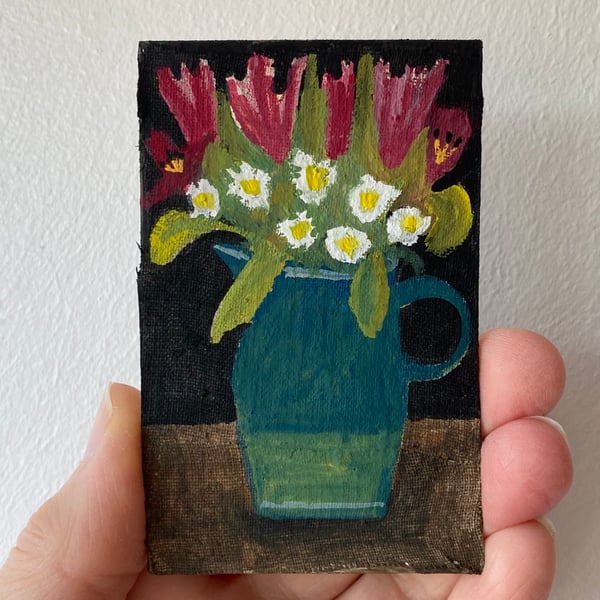 Image of tulips and feverfew in a jug