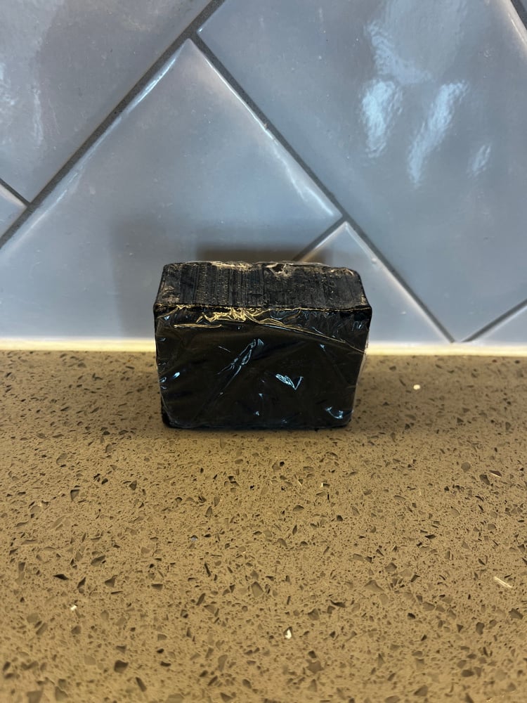 Image of  Black Soap with exfoliating bag