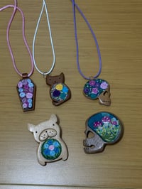 Embroidered Pins and Neckalces in handcarved wood 