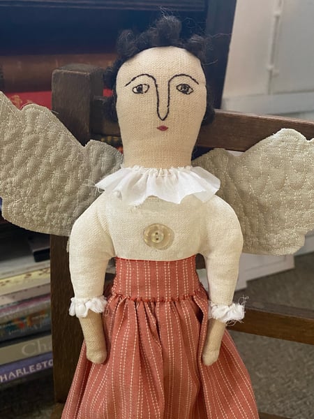 Image of A folk art angel in striped skirt