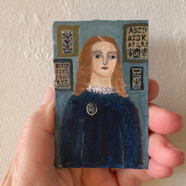 Image of Woman by a sampler wall - tiny portrait 