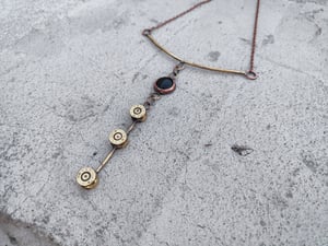 3 bullet casings and black stone necklace 