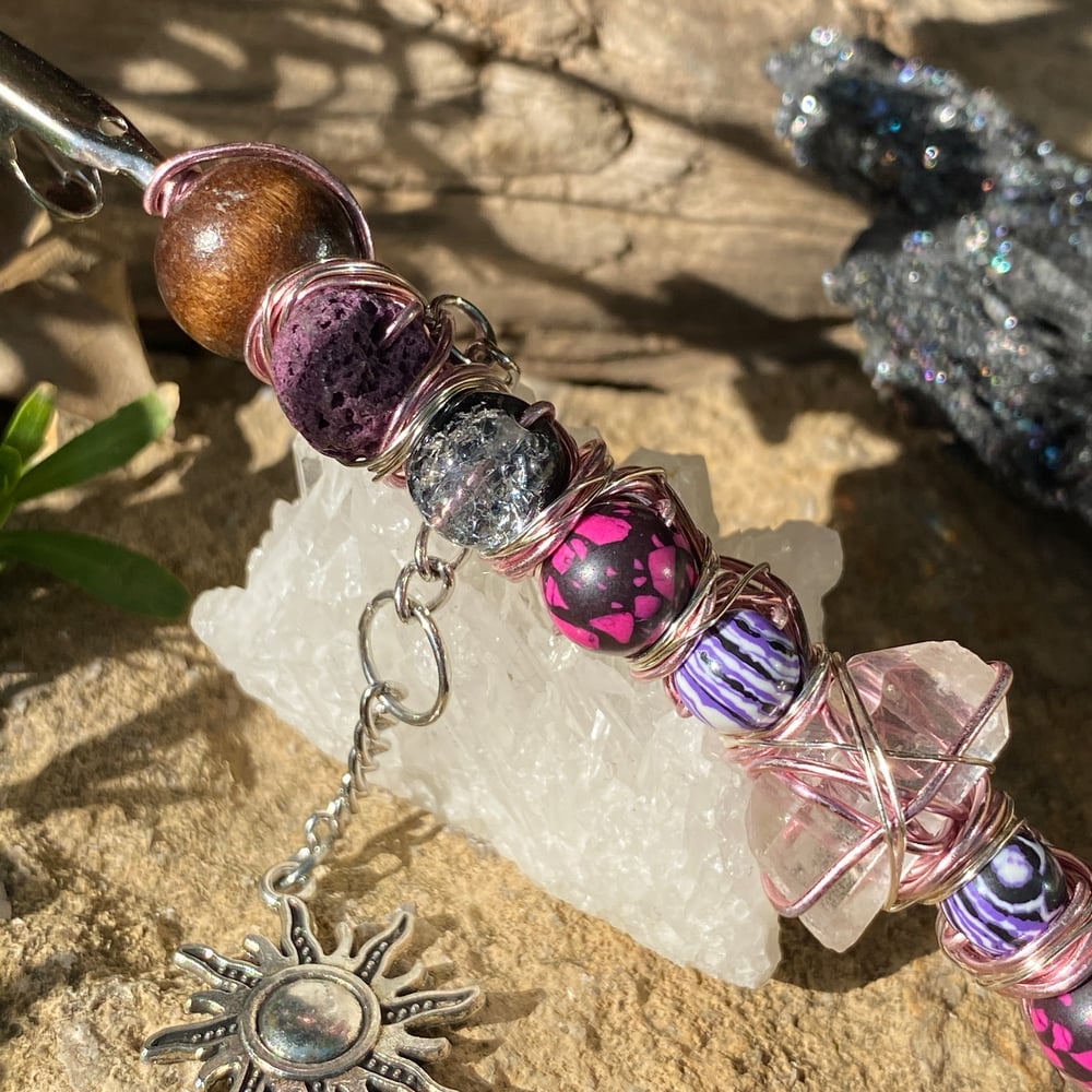 Image of magenta sun roach clip