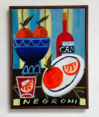 Negroni with oranges on blue and yellow stripes