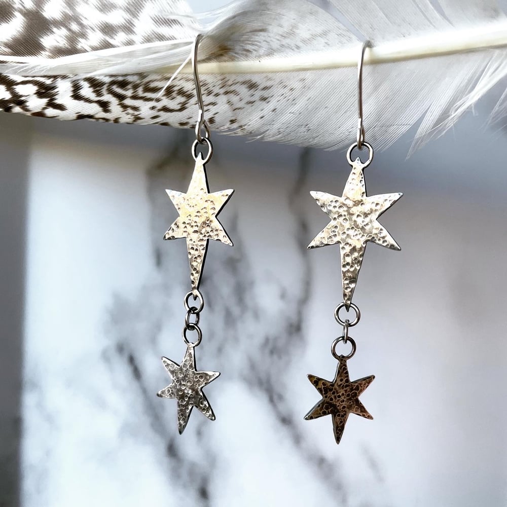 Image of Handmade silver cosmic star dangly earrings. Celestial silver starry earrings. 