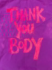 Image 1 of Gentle Pink T Shirt with orange peachy text (medium)