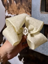 Ivory ribbon bow with concho