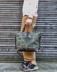 Image 1 of Carryall  tote bag in olive green waxed filter twill with leather bottom and cross body strap