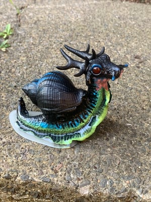 A Single Instance of SCP-111, “Dragon Snails”, The  Glowdrake®