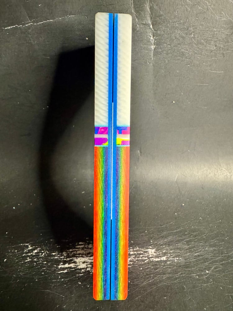 Image of White Faux Ivory & Rainbow Carbon Fiber GLOW Knife Scales