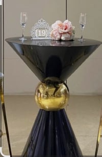 Image 1 of Bar table   With its sleek design and highlighted gold details in the middle