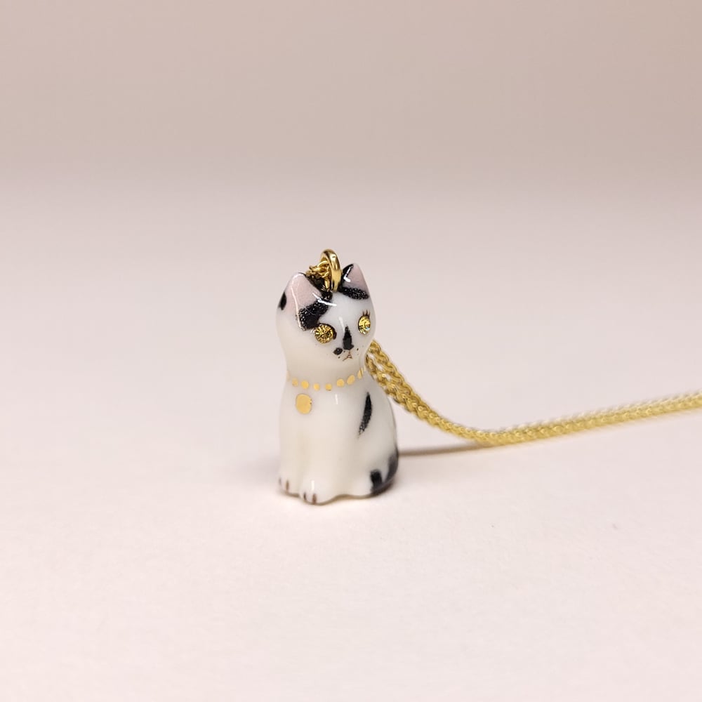 Image of Black and White Patchy Porcelain & Gold Vermeil Sitting Kitten Pendant 