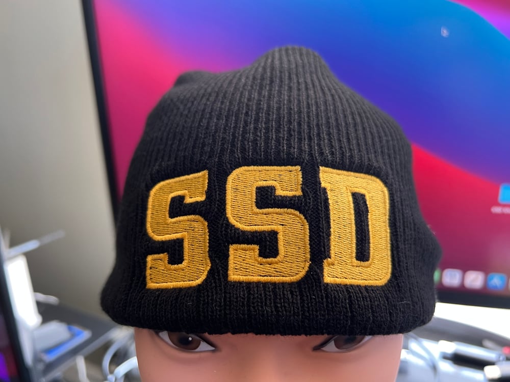 Black New Era Knit beanie hat with Solid Gold SSD logo 