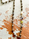 peacock pearl rosary style necklace with peridot, pearl, and iolite