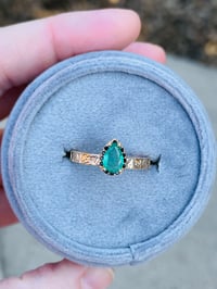 Image 1 of 14k gold emerald halo engagement ring with engraved vine band