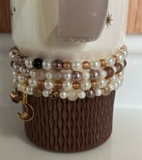 Image 4 of Starlight Shimmer Gold, Champagne, and Cream Tumbler Bracelet Stack
