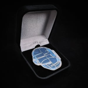 Image of R.A.M. 10 Year Anniversary Glass Helmet Pin