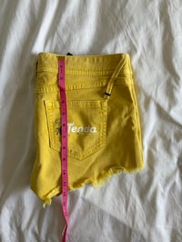 Image 7 of Vintage Y2K low rise yellow shorts with graphic and stud details