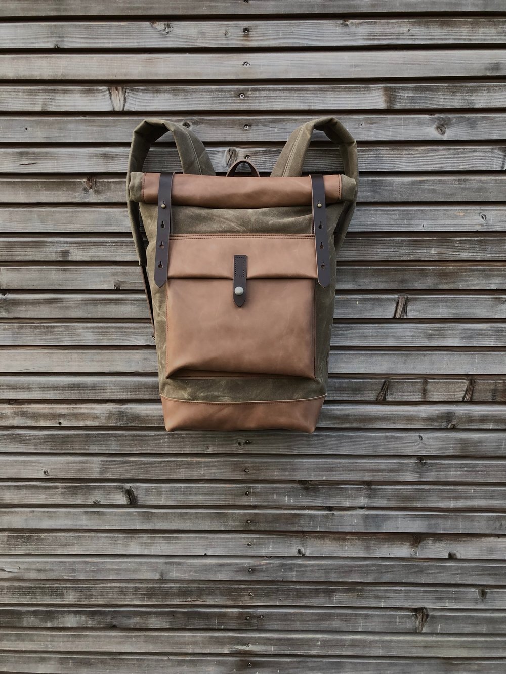 Image of Waxed canvas backpack with roll up top and oiled leather bottem in dark taupe