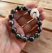 Image of Hand Knotted Tahitian pearl bracelet with puka shell clasp
