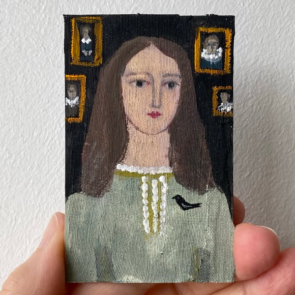 Image of woman in pale green with bird brooch