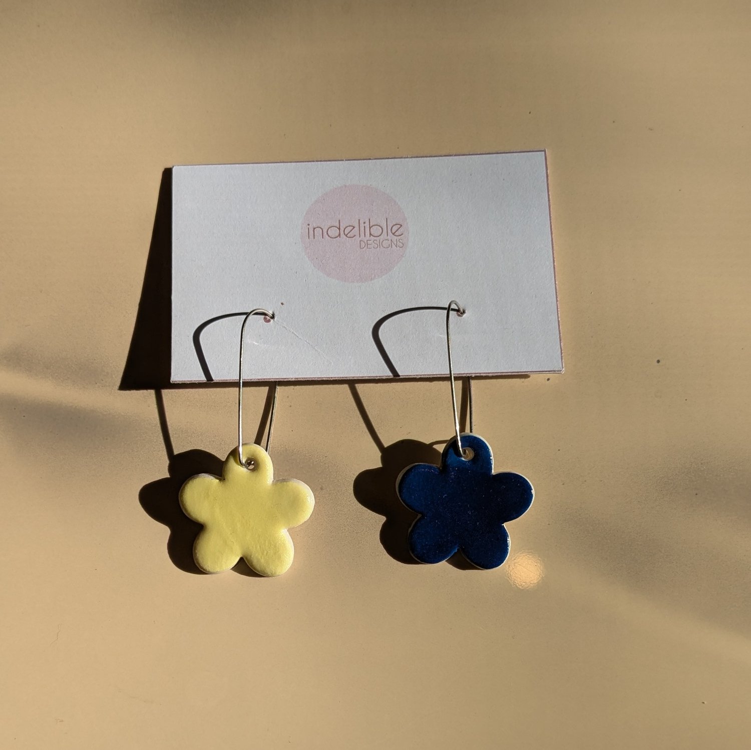 Image of yellow and blue daisy asymmetrical earrings