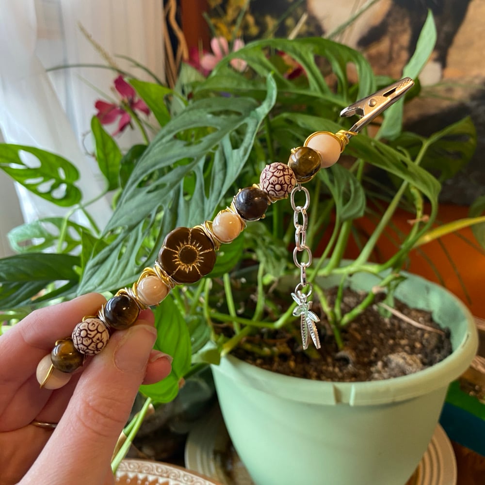 Image of floral latte roach clip 