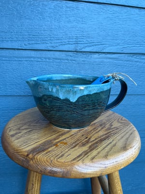 Image of Pouring Bowl, speckled black with blue rim. PB 13