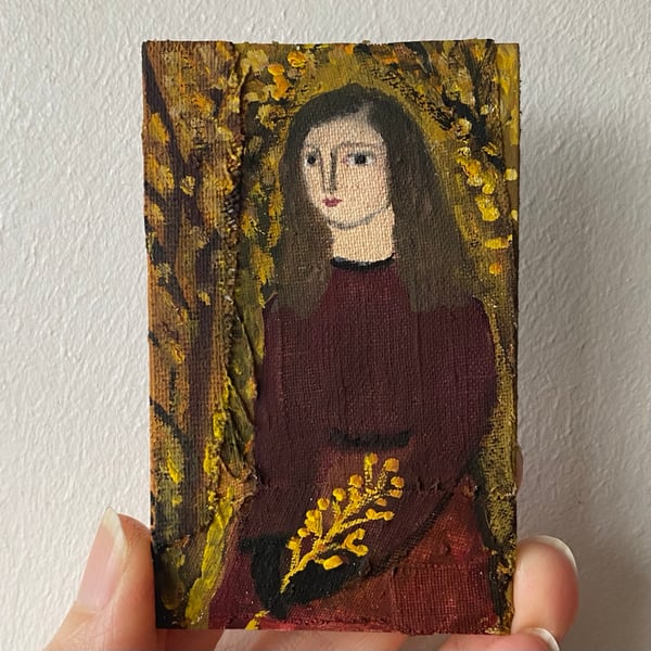 Image of Woman in dark red with golden leaves 