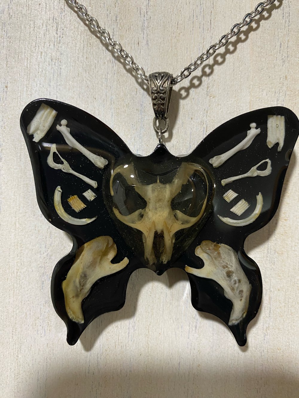 Butterfly skull pendant