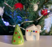 Image 1 of Little House with lights and a Christmas Tree.