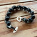 Image of Hawaiian Kupe'e shell bracelet with puka and cowrie lip clasp