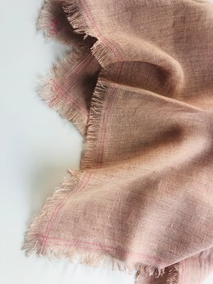 Image of ruby pale orange linen towel with pink stitching