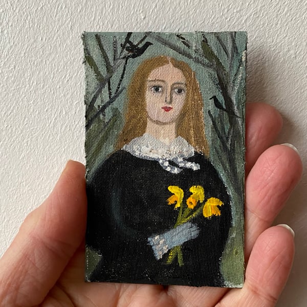 Image of woman in winter with daffodils - tiny painting 