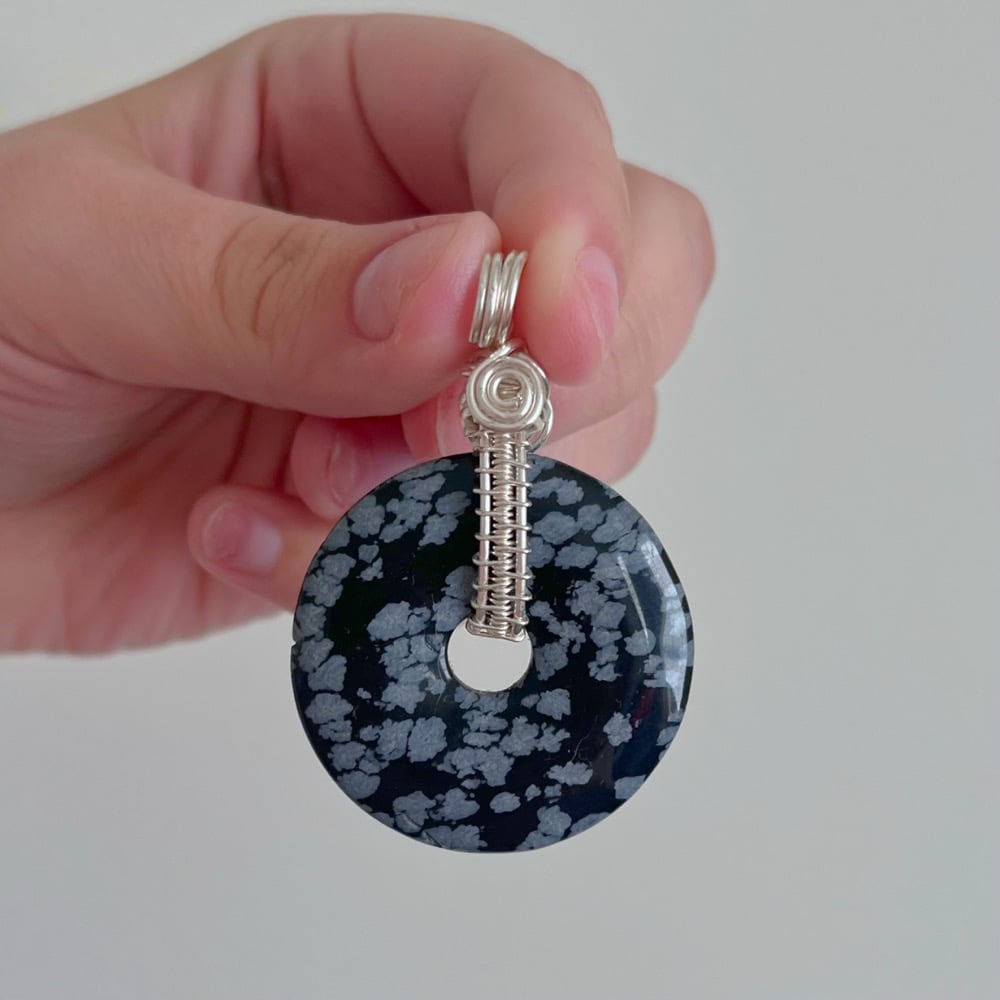 Image of snowflake obsidian fidget spinner pendant