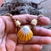 Image of Hawaiian sunrise shell necklace with golden pukas and a locking seaglass clasp