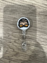Ojitos Lindos badge reels 