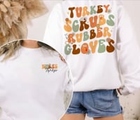Image 1 of  Turkey, scrubs, and rubber Gloves