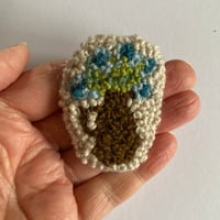 Brown jug brooch 4/26