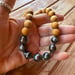 Image of Tahitian pearl necklace with sandalwood beads and a tiger puka shell clasp