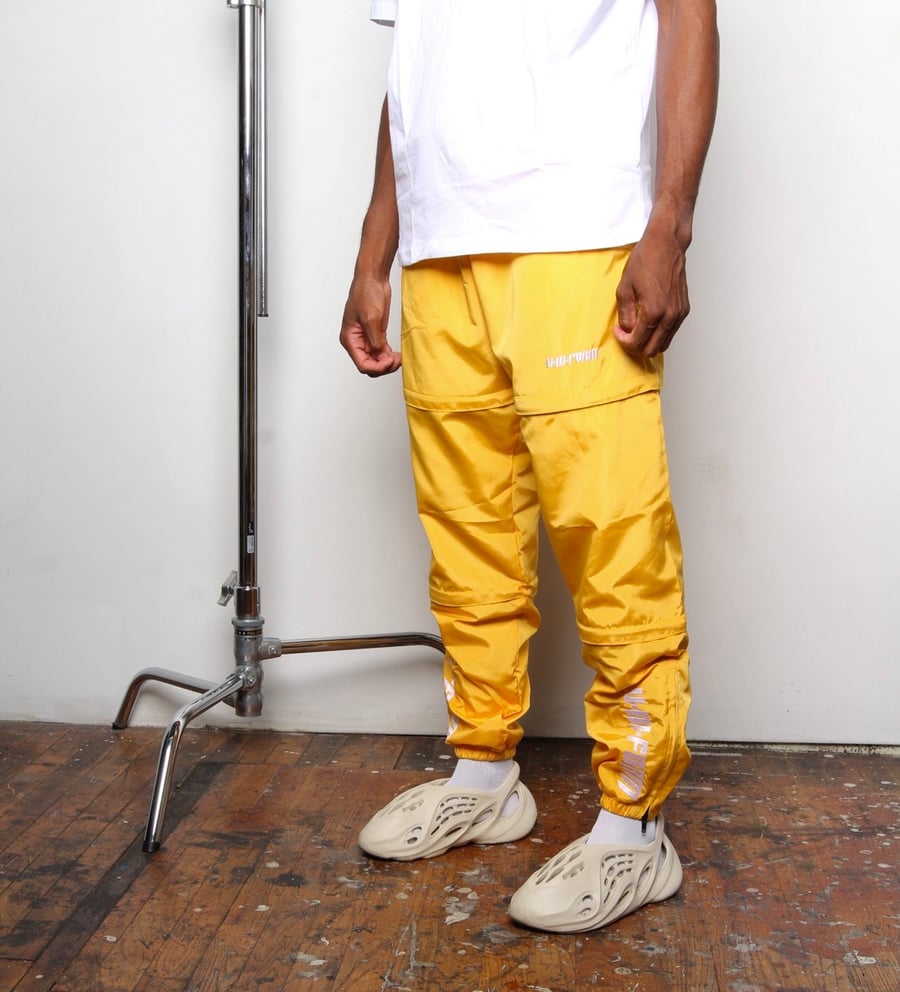 Image of UNFM Gold  Phase 001 Zip Away Pants