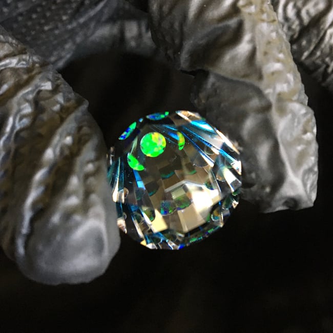 Faceted gem with opal and blue tip