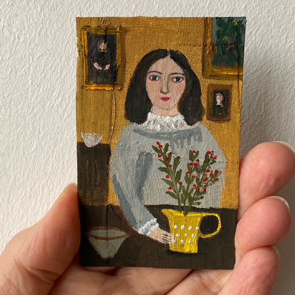 Image of Woman at a table with yellow jug and berries - tiny painting 