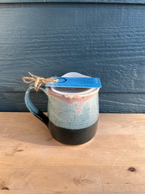 Image of M38 Black Speckled Glaze With Pinkish Blue Lip White Inside